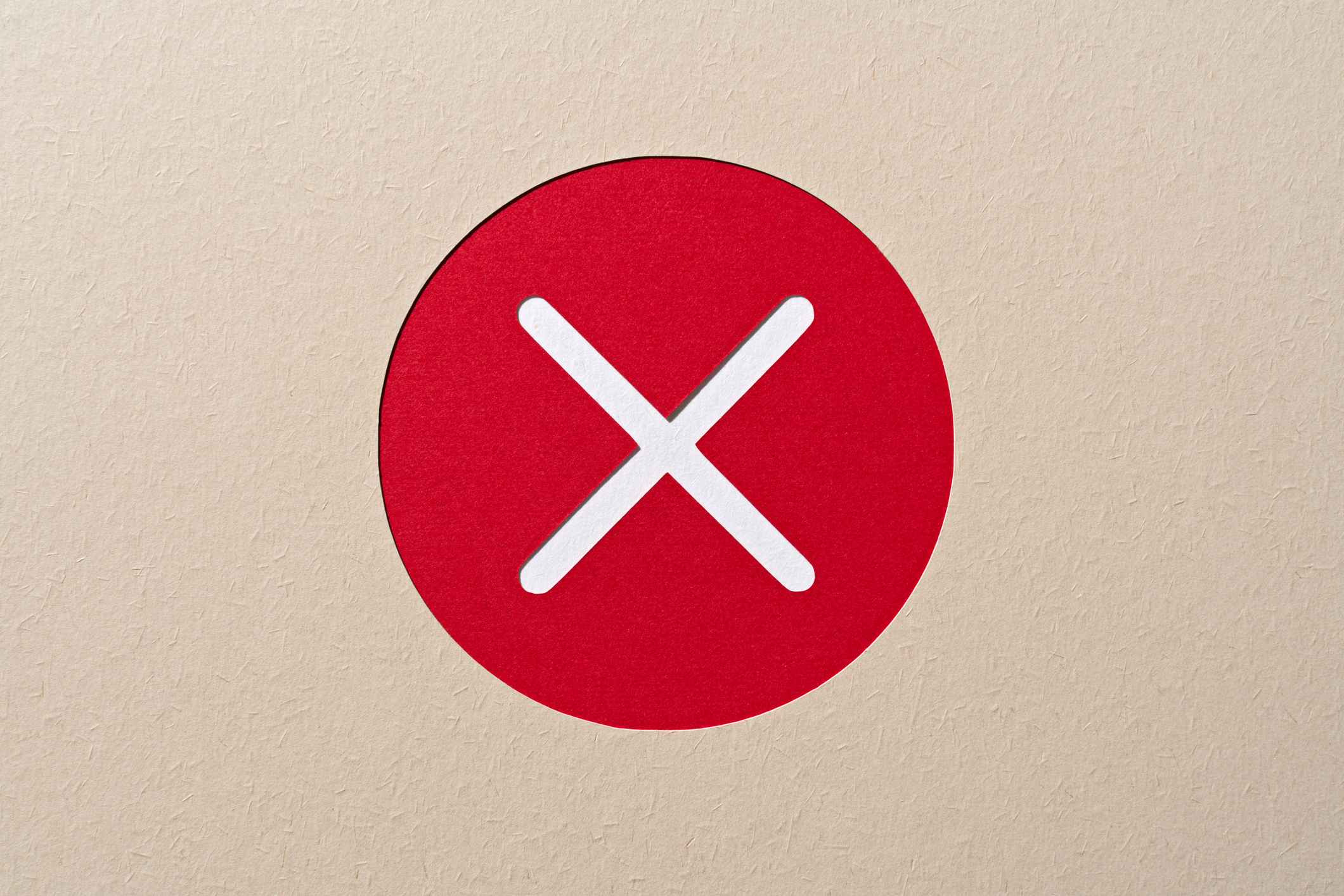 Paper Craft of Red Cross Mark in a Circle Frame on Beige Background.