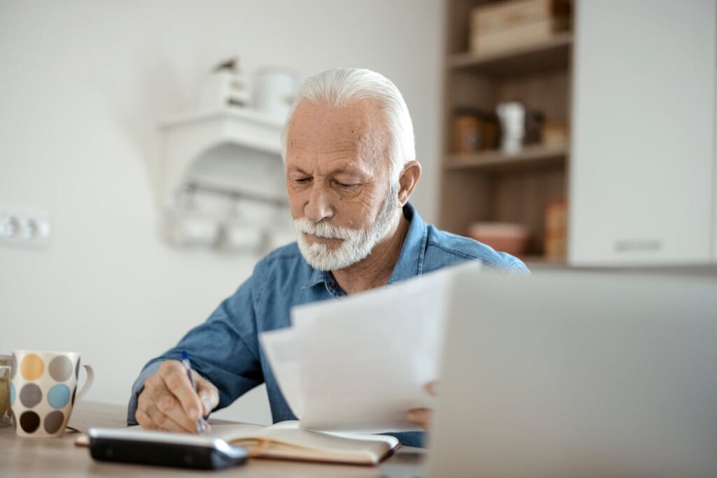 A seated person holding documents.