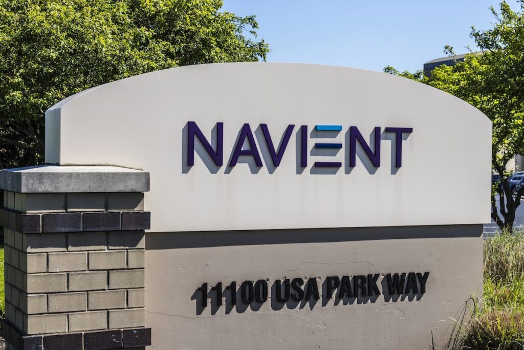 Outdoor sign for the Navient corporate headquarters, featuring the company logo with purple and blue letters on a white background. This image provides visual context for the article discussing the rollout of compensation checks to borrowers following the 2024 settlement between the CFPB and Navient over alleged servicing misconduct. Source: The College Investor