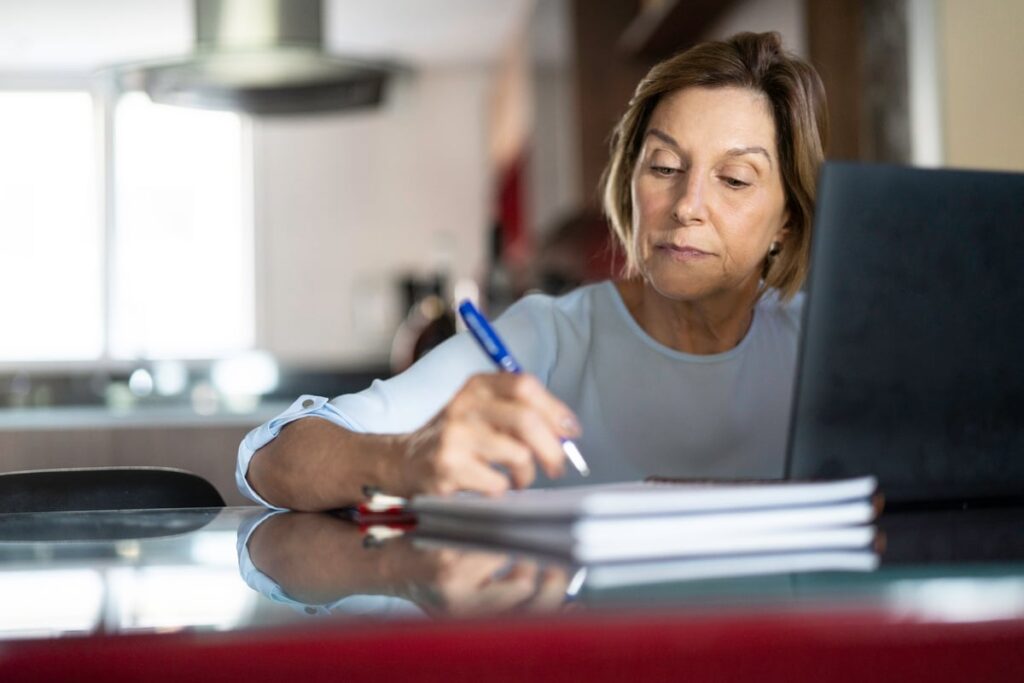 A person at a laptop writing.