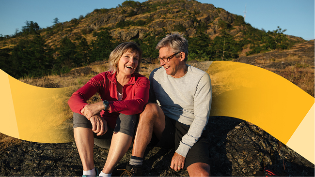 An older couple sitting and laughing