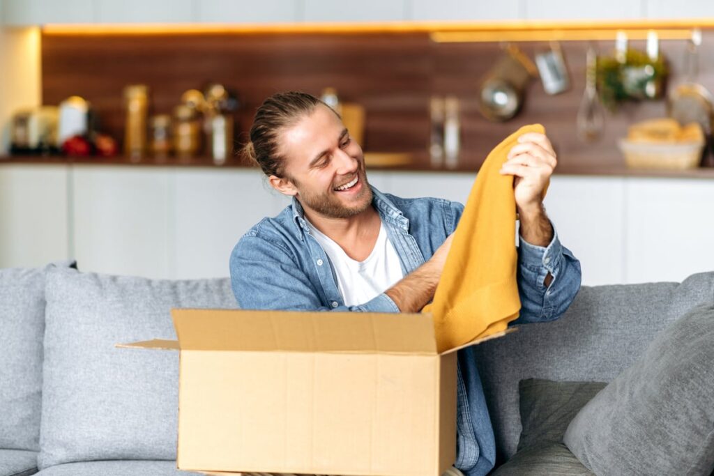 Person opening box of clothes.