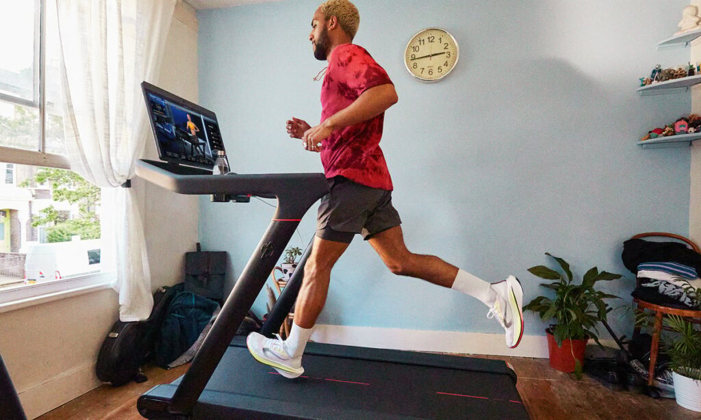 A person running on a Peloton treadmill.