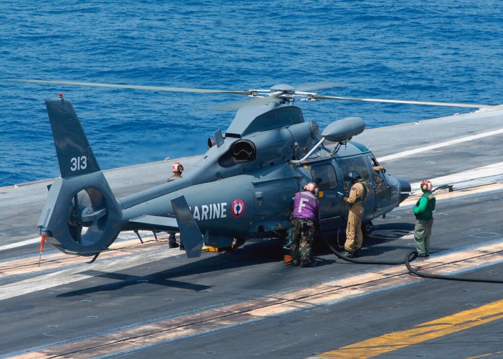 A helicopter on an aircraft carrier.