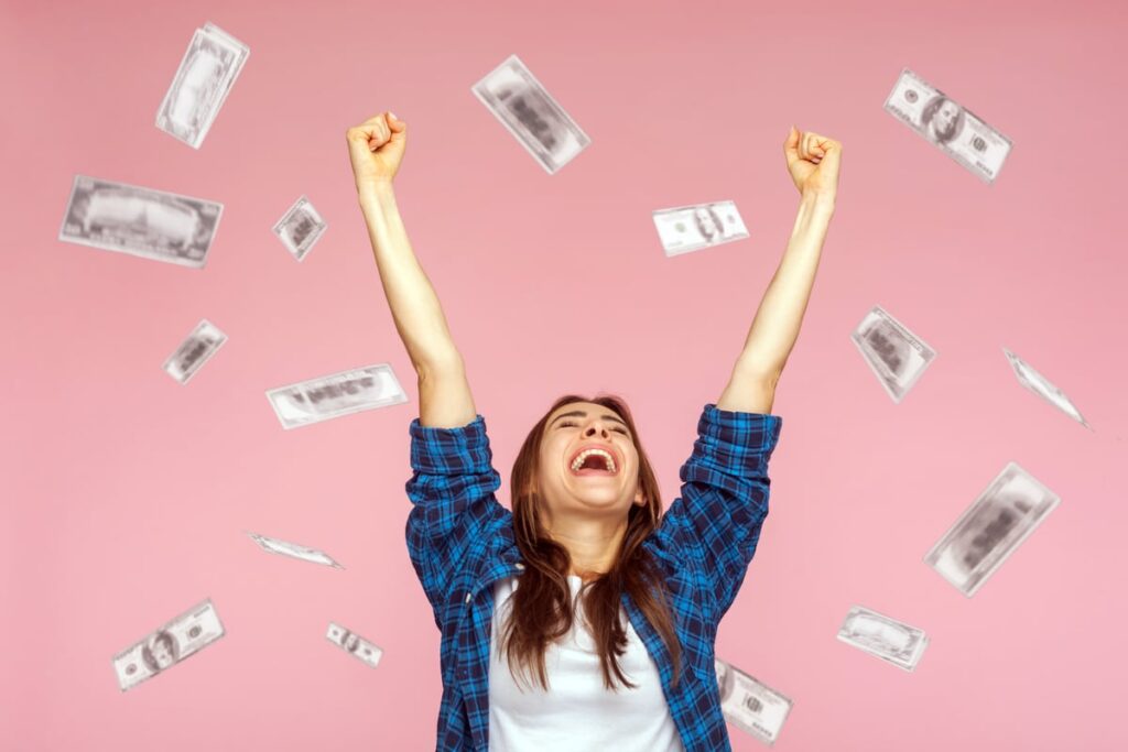 A person celebrating as money rains down.
