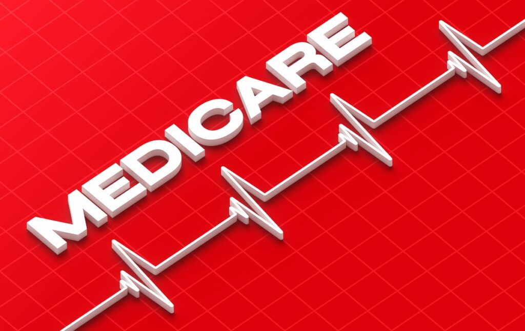 A red background with the word Medicare in white and an electrocardiogram.
