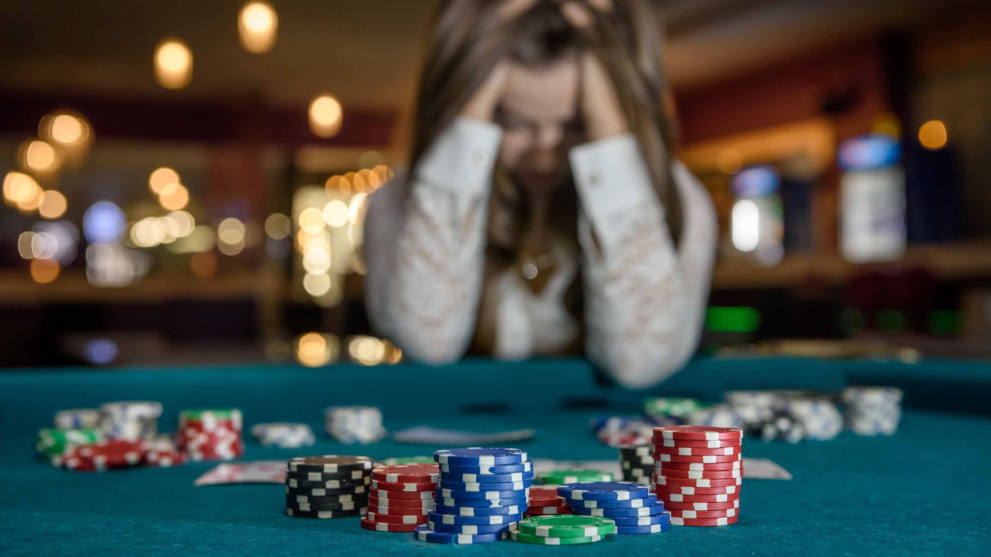 picture of distraught woman at a gambling table