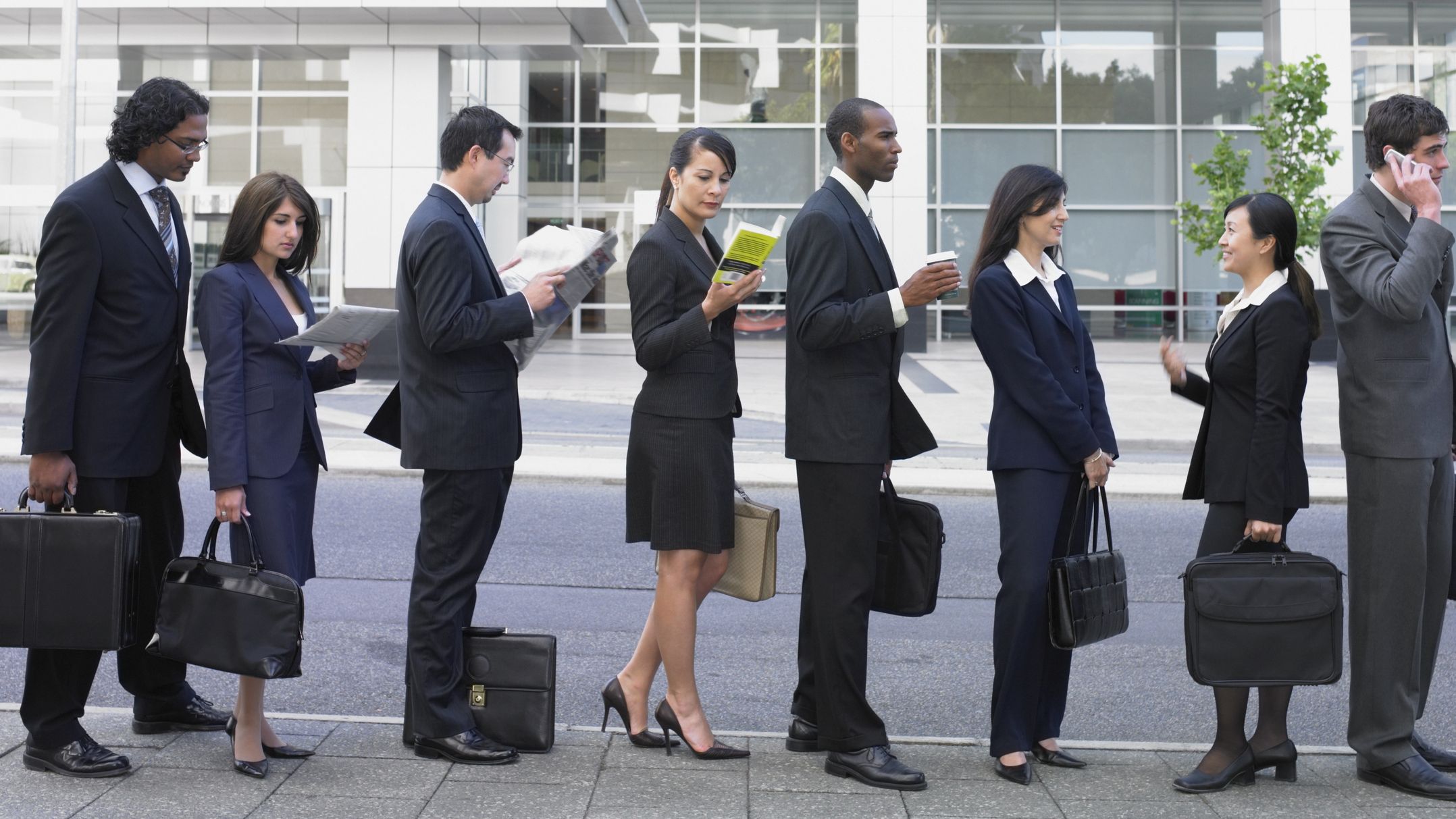 A line of business people or prospective financial advisers waiting outside.
