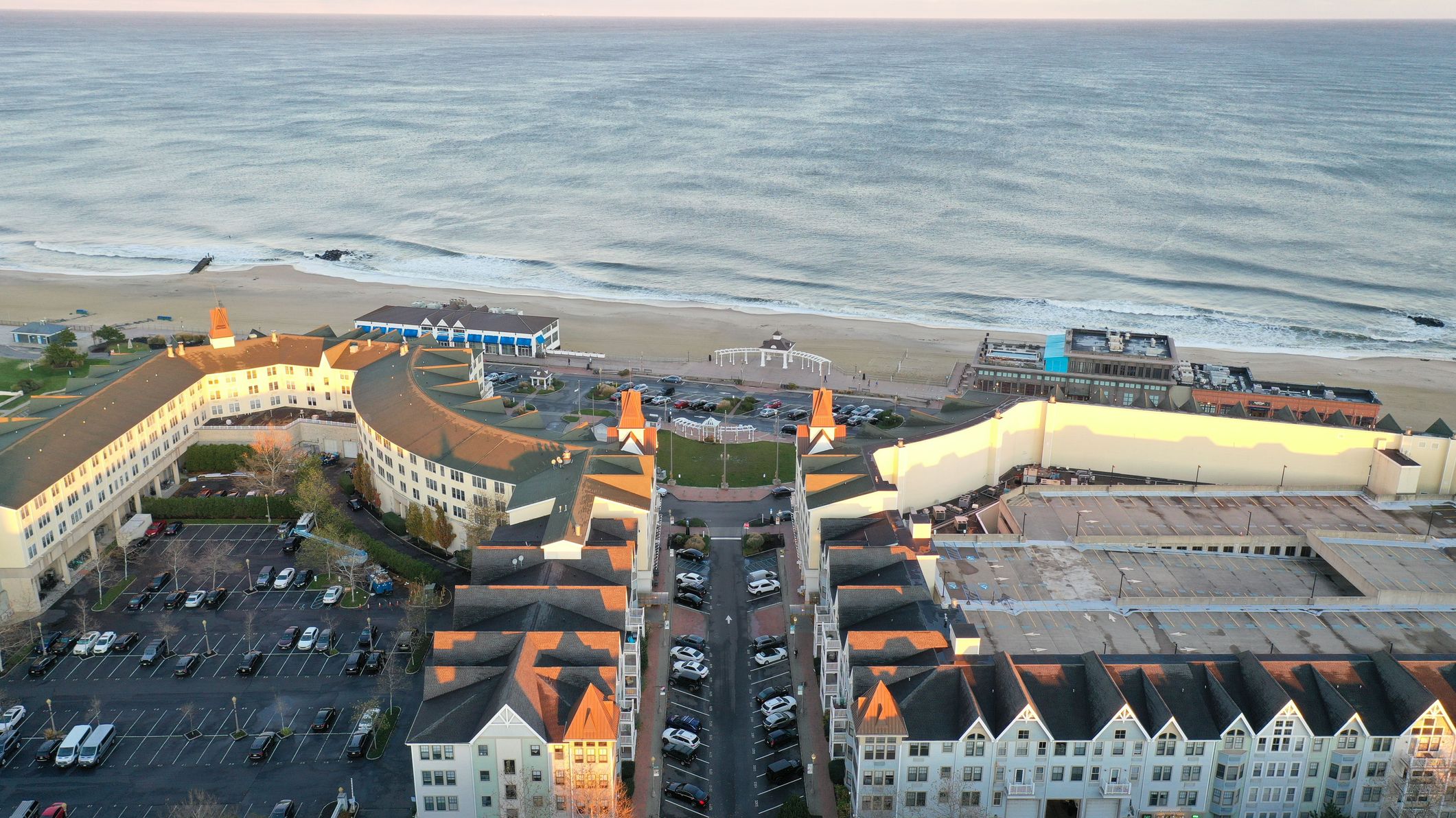 A drone shot of the Pier Village in Long Branch, New Jersey, and the Atlantic Ocean at sunset