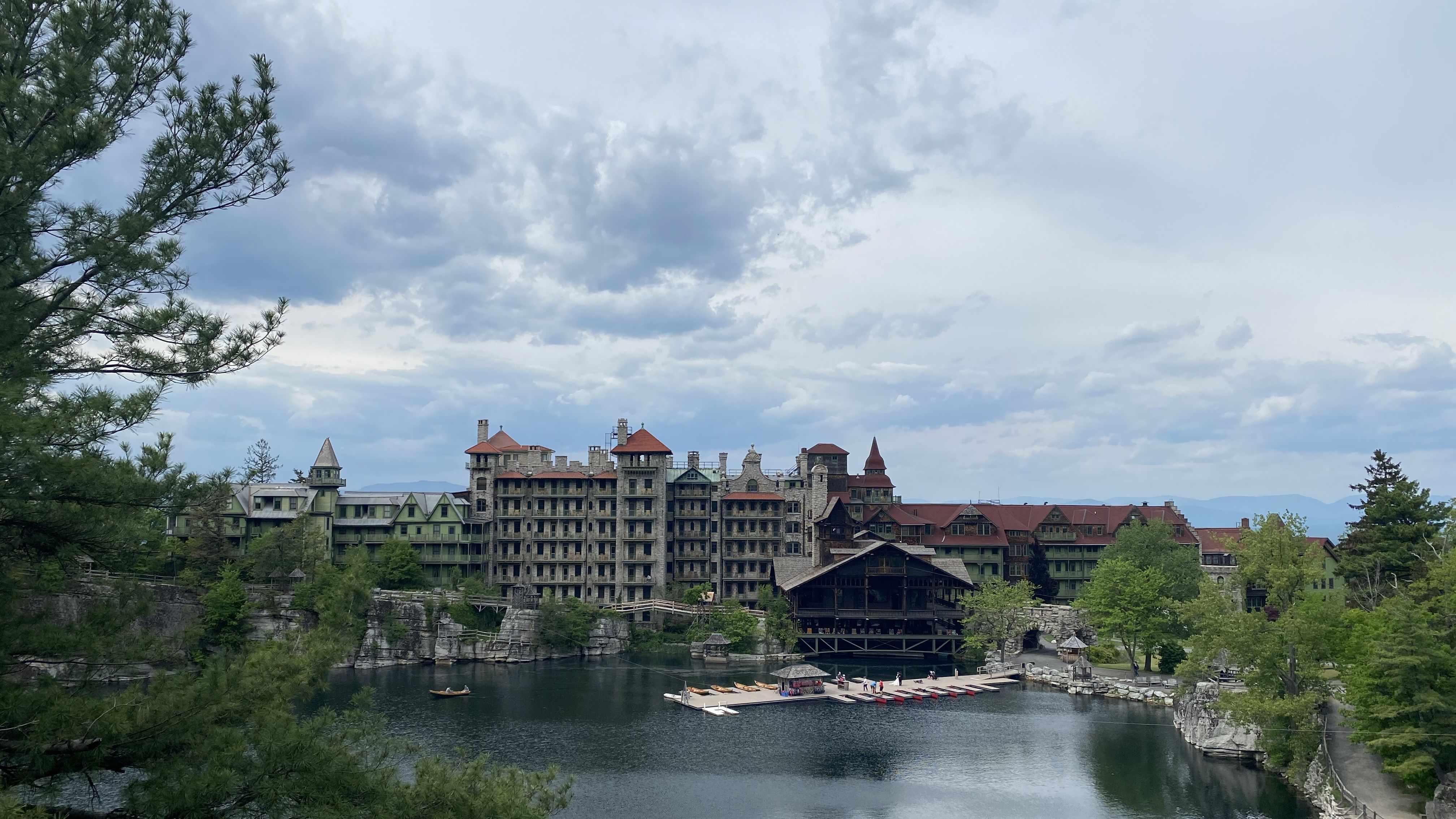 Mohonk Mountain House sits atop a lake on a bright day.
