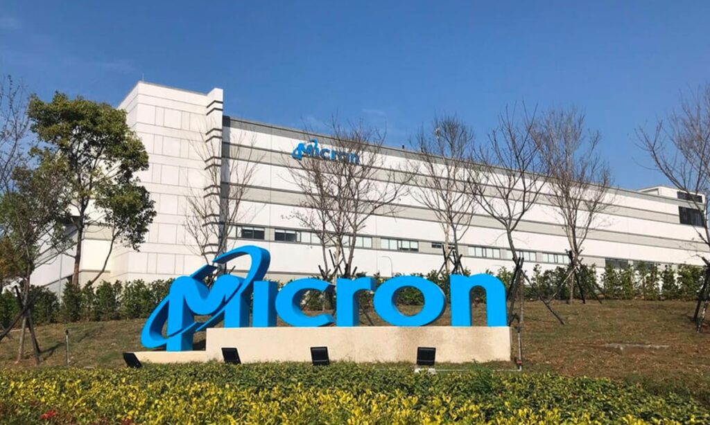 Micron logo in front of a company building.