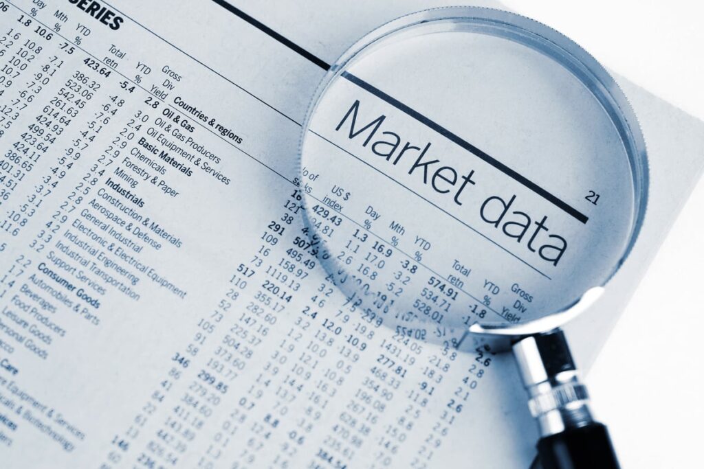 The words "Market data" on a newspaper under a magnifying glass.