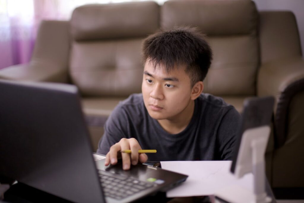Analyst with laptop sitting next to couch.
