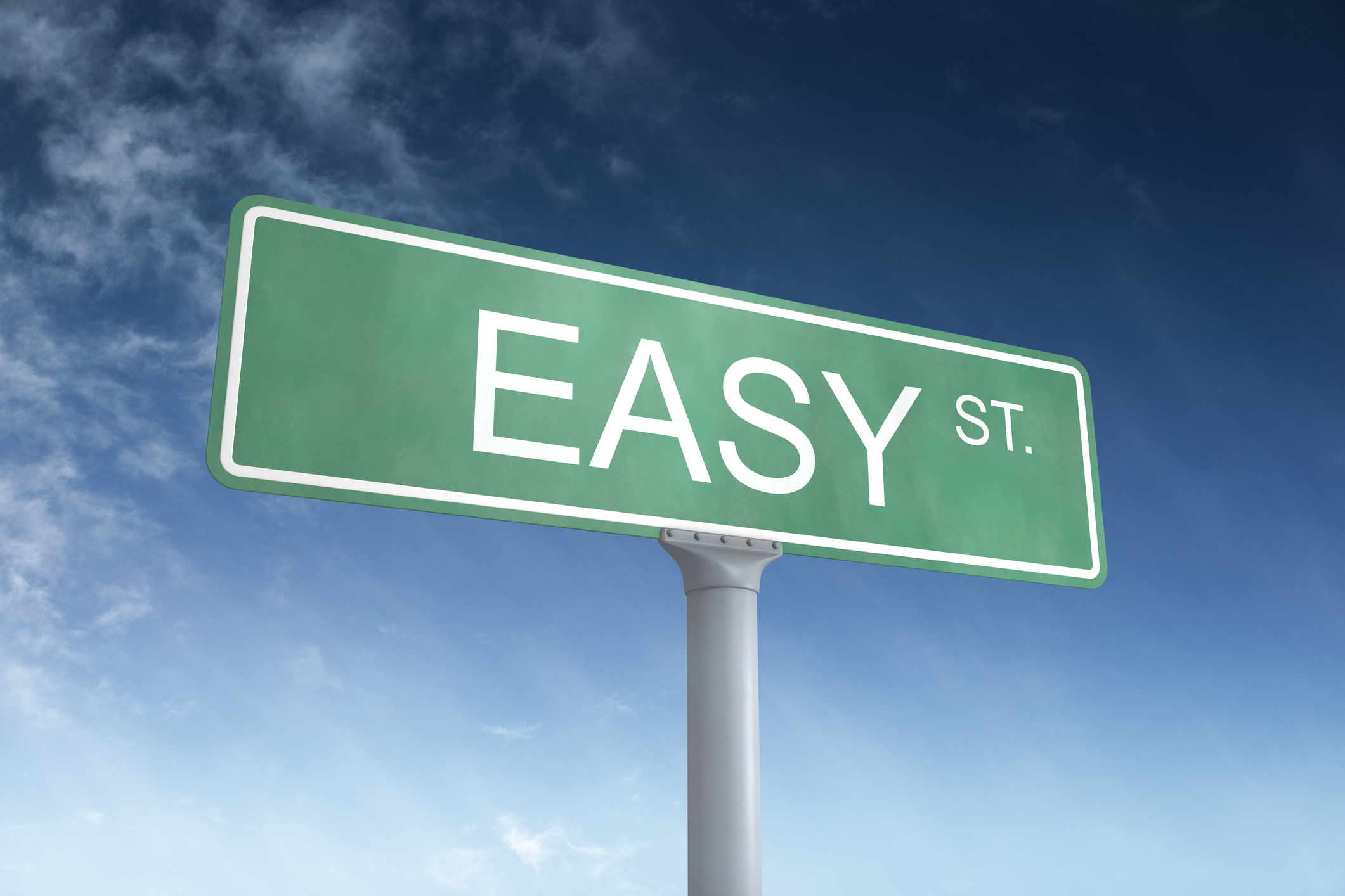 Green street sign that reads Easy St with a blue sky in the background