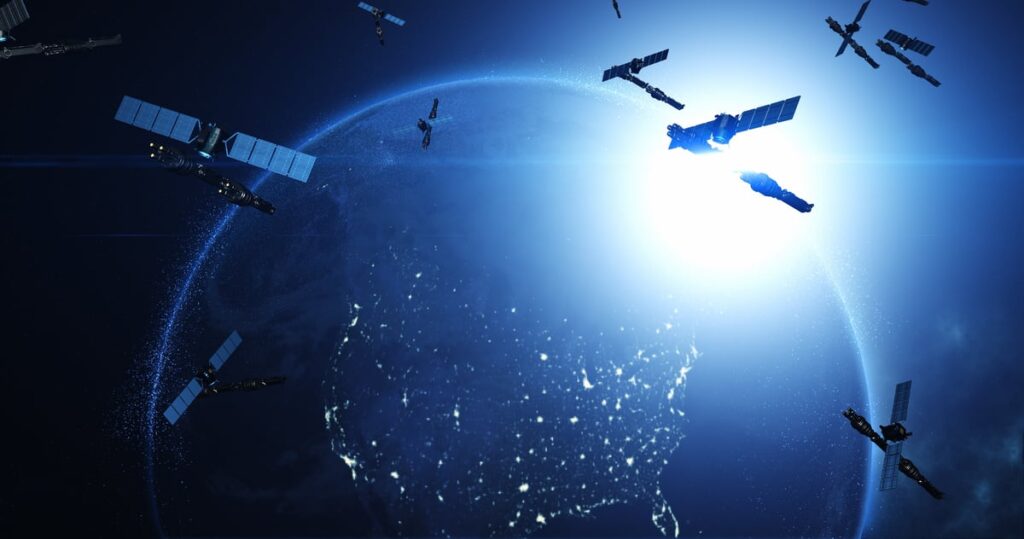A rendered image shows several satellites orbiting planet Earth.