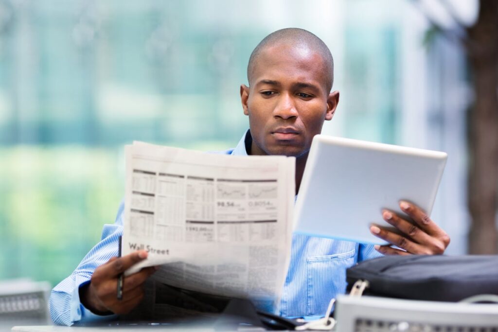 An investor reads a newspaper article.
