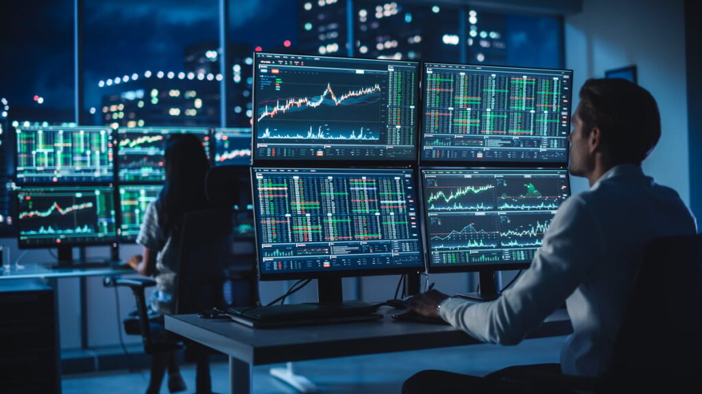 Financial traders in office at night.