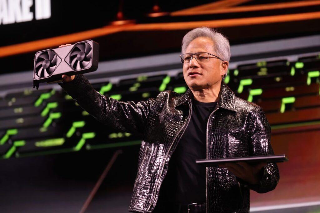 Jensen Huang on stage at a conference showing off Nvidia's products.