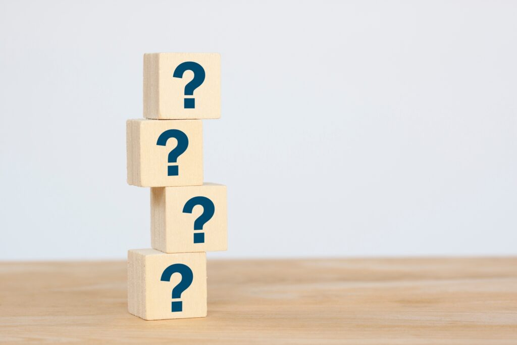 Group of wooden cube block on table, thinking different, way how to find answer, copy space for text on grey background.