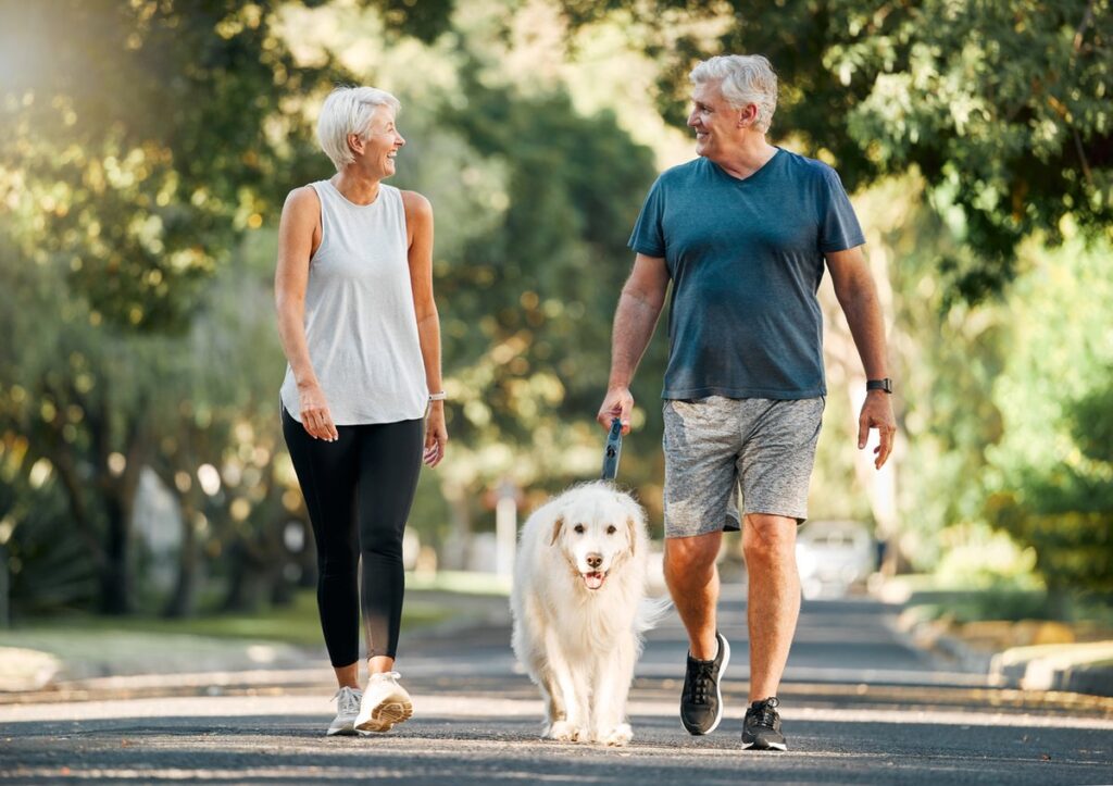 Couple taking their dog for a walk.