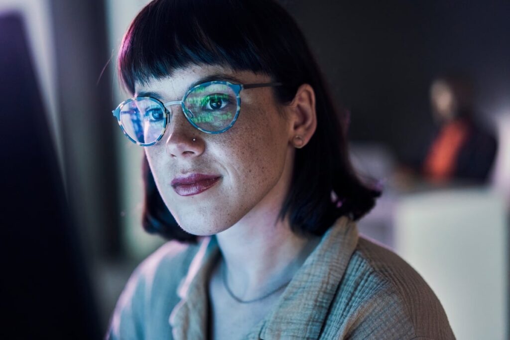 A woman coder working on the computer.