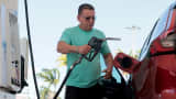 A customer fills his vehicle with fuel at a gas station in Miami, April 13, 2026.