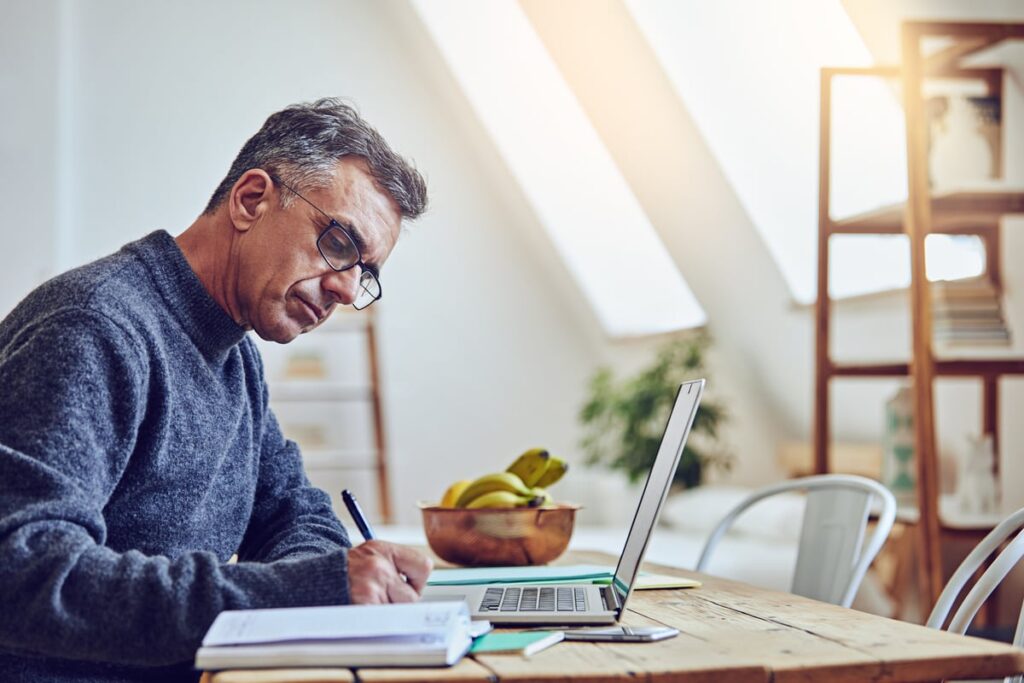 A person at a laptop writing.