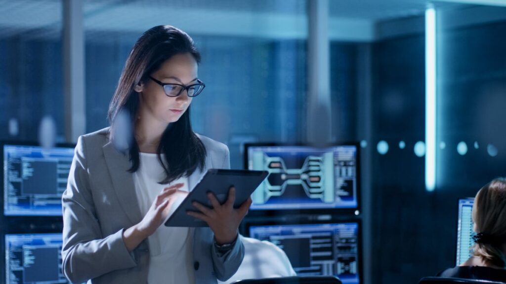 Analyst working on a tablet in office.