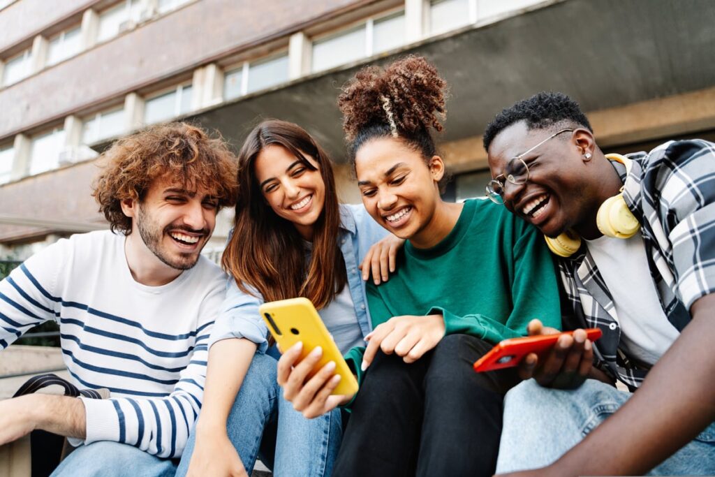 People smiling at a smartphone.