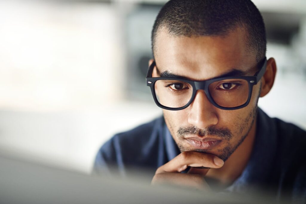 Person looking intently at computer screen.
