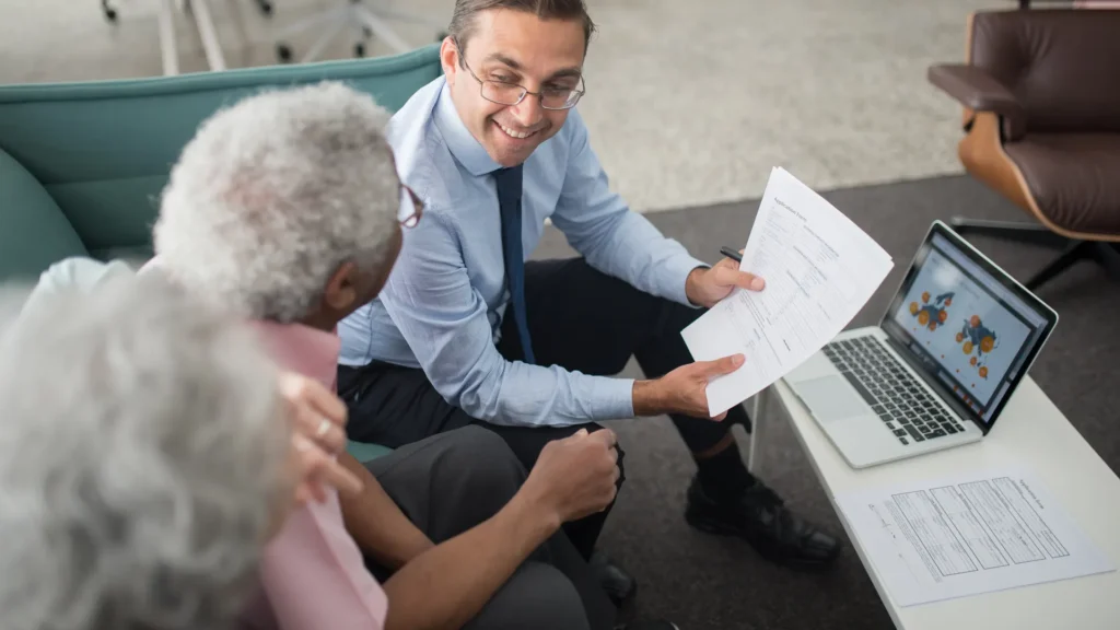 Financial adviser going through pension and estate paperwork with a retired couple