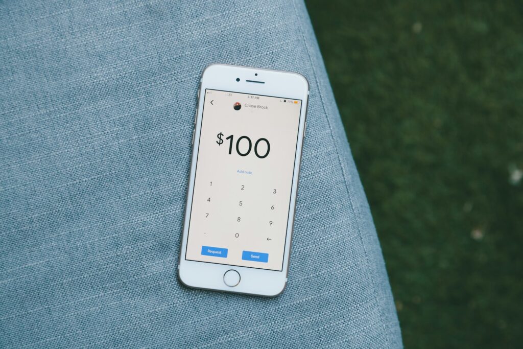 white samsung android smartphone on gray textile; money tracker app