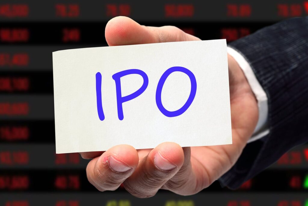 A hand holding up a card that says "IPO".