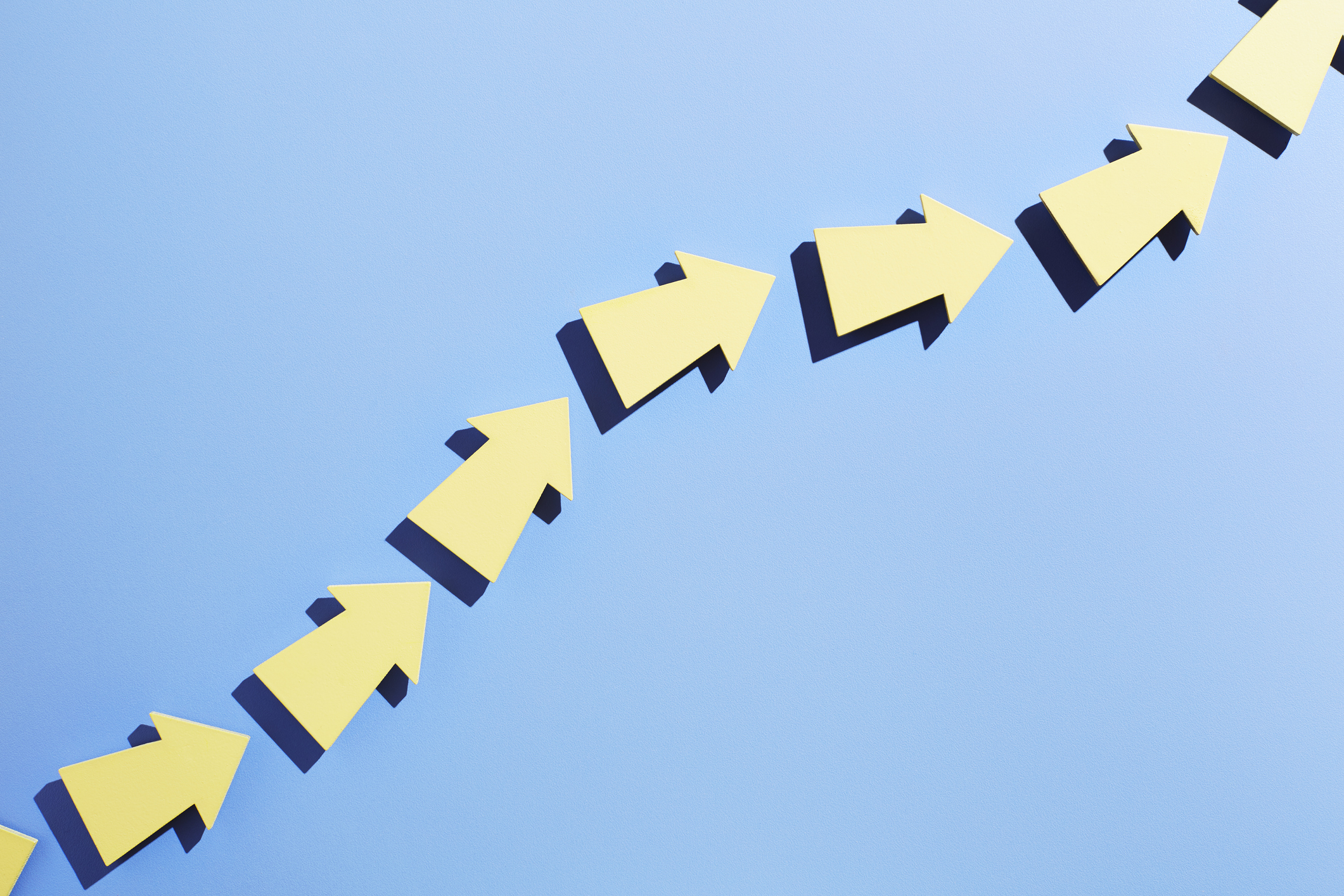 A group of arrows moving up together in a line