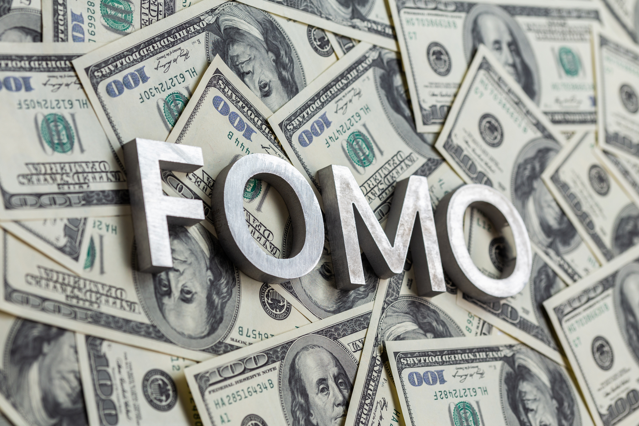 FOMO text on paper dollars.