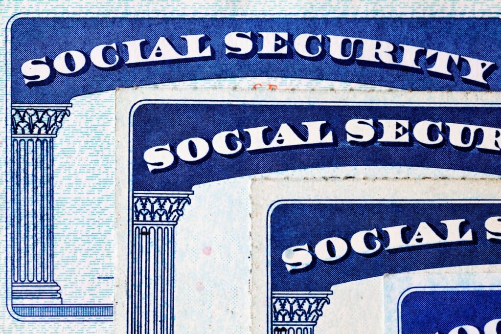 Close-up of overlapping vintage Social Security cards in blue and white