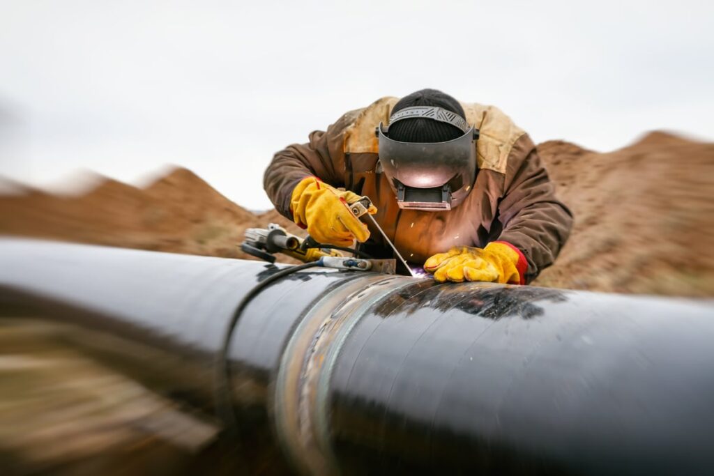 Worker soldering a gas pipeline.