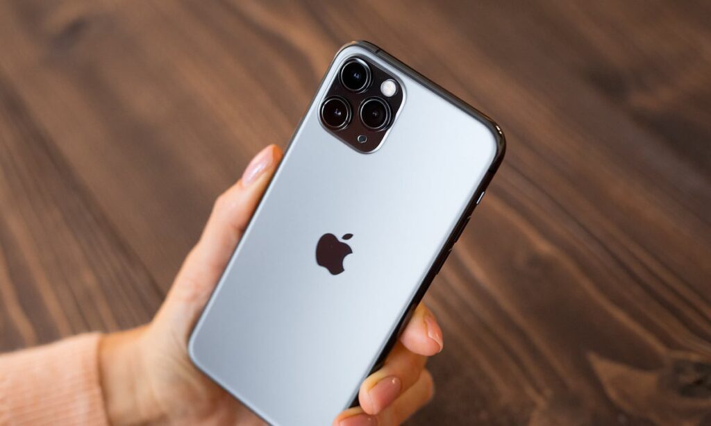 A person holding an Apple iPhone.