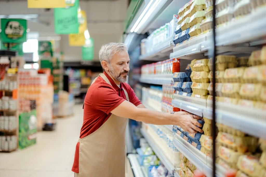 Person stocking shelves at a grocery store.