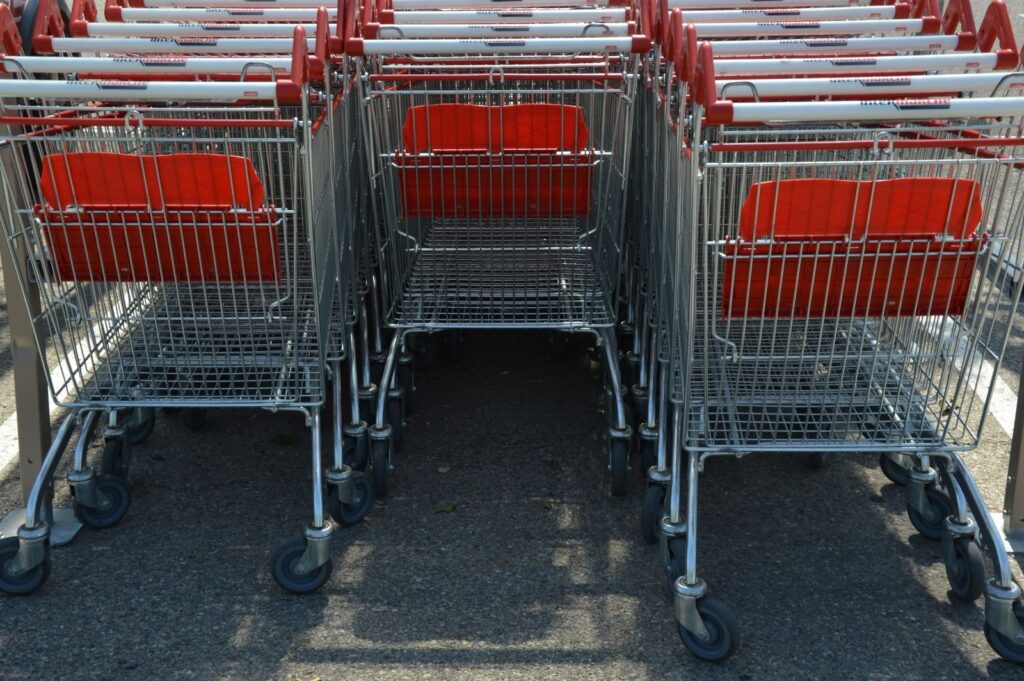 Rows of shopping trolleys lined up in a car park